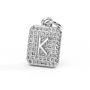 Close-up of a silver rectangular pendant featuring a crystal-encrusted letter K detail