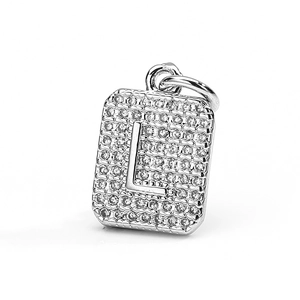Macro shot of square zircon pendant featuring a polished 3D letter L on a pave background