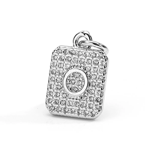 Macro shot of rectangular pendant in copper with zircons and letter O engraving