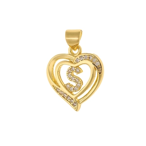 Macro shot of gold heart pendant featuring a micro-pave zircon letter S design