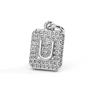 Detailed macro of a rectangular silver pendant with paved zircons and a 3D letter U