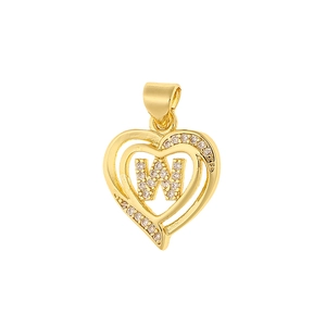 Macro detail of gold-plated copper heart pendant with zircon-encrusted letter W
