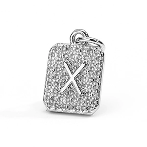 Macro detail of silver rectangular pendant with letter X and pave cubic zirconia stones