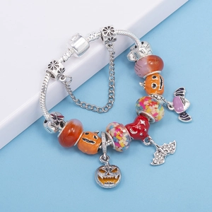 Halloween charm bracelet with pumpkin and bat pendants on a snake chain