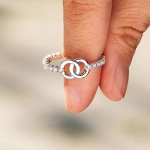 Macro detail of silver interlocking rings with pave-set shimmering stones for women