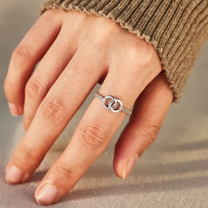 Close-up of interlocking double ring with sparkling micro-pave zircons on a hand