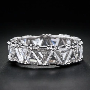 Macro shot of silver ring with full circle triangle cut pavé set cubic zirconia stones