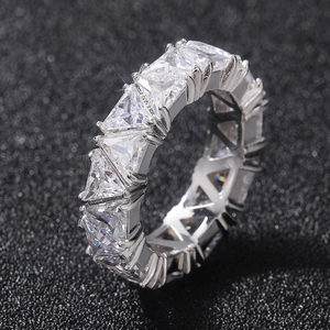 Macro view of full eternity band featuring triangle-cut cubic zirconia in claw setting