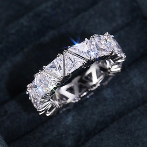 Macro shot of silver ring featuring triangular cut cubic zirconia in a prong setting