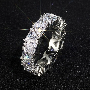 Detailed close-up of a luxury eternity band ring with pavé set zircon crystals on black