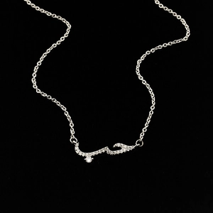 Macro shot of silver Arabic الحب pendant with pavé cubic zirconia on black background