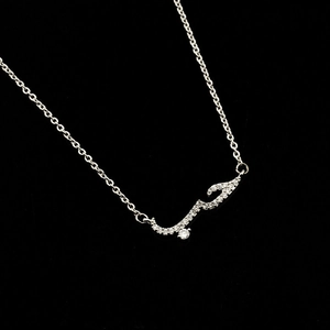 Macro detail of Arabic Love calligraphy necklace with micro-pave zircons in silver
