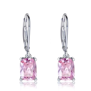 Macro detail of rectangle pink gemstone earrings with silver leverback closure on white