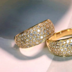 Macro view of luxury gold multi-row pave zircon ring with shimmering geometric design