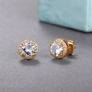 Macro shot of rose gold halo stud earrings featuring central round-cut zircon and pavé detail