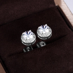 Detailed view of silver zircon halo stud earrings with round brilliant cut center stone