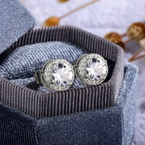 Macro shot of silver halo stud earrings with brilliant-cut cubic zirconia in velvet gift box