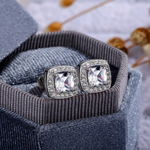 Macro detail of cushion-cut halo earrings with cubic zirconia in a velvet box