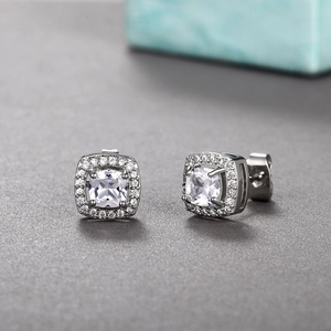 Close-up of elegant square halo stud earrings with zircon inlay and silver plating