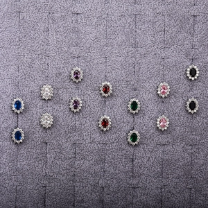 Detailed view of oval zircon stud earrings in multiple vibrant colors on display