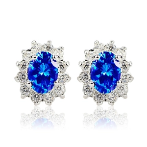Elegant silver sunburst halo stud earrings with blue gemstone and micro-paved zircons