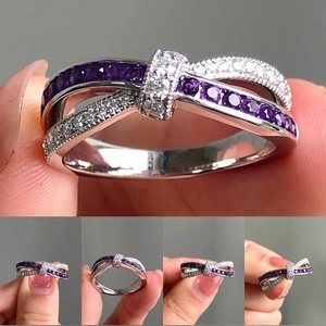 Crossed geometric silver ring featuring purple and white round-cut pavé zircons