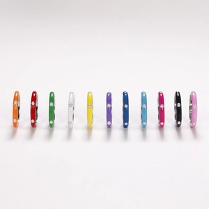 Close-up of set of 11 colorful enamel rings with inlaid sparkling white zircon stones