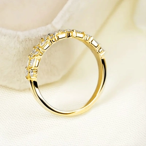 Macro view of a gold-plated multi-layer band ring with sparkling crystal pave setting