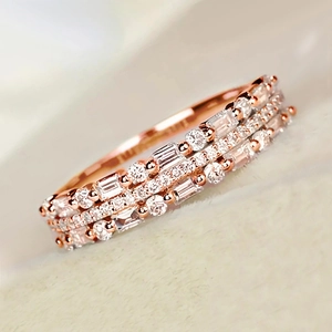 Detail of rose gold triple-layer ring with sparkling square and round cubic zirconia