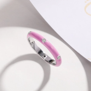 Close-up of pink enamel ring featuring micro-set cubic zirconia stones in silver finish