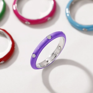 Detail of colorful enamel stackable rings featuring shimmering inlaid zircon stones