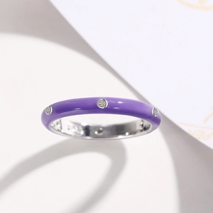 Detailed macro view of a slim purple enamel ring featuring sparkling zircon stone inlays