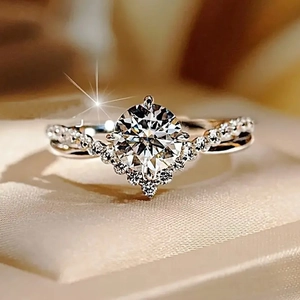 Close-up of zircon wedding ring with round center stone and V-shaped pavé band