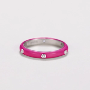 Detailed view of pink enamel coating and sparkling cubic zirconia on a silver-toned ring
