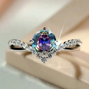 Macro shot of V-shaped band with shimmering round opal gemstone and sparkling pavé diamonds