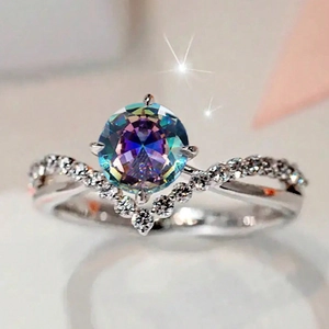 Macro detail of V-shaped zircon ring with rainbow center stone and pavé setting