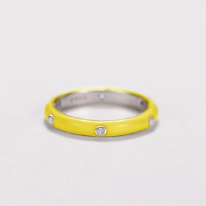 Macro shot of S925 silver ring with yellow enamel finish and embedded cubic zirconia