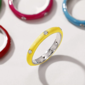 Macro view of colorful enamel rings with inlaid sparkling cubic zirconia crystals