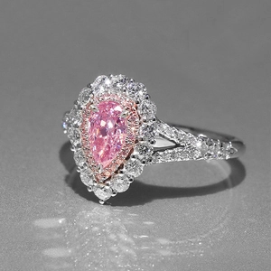 Luxurious pear-shaped pink gemstone ring with double halo white crystal settings