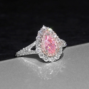 Luxurious pink pear-shaped ring with double halo diamonds and split shank detail
