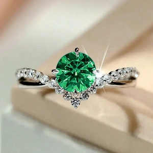 Elegant V-shaped silver ring with a large round green zircon and pavé diamond-like accents