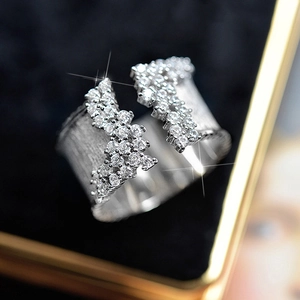Macro shot of silver wide open ring with double rows of sparkling pave set cubic zirconia