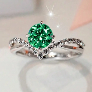 Macro shot of V-shaped ring with emerald green zircon and diamond-encrusted band