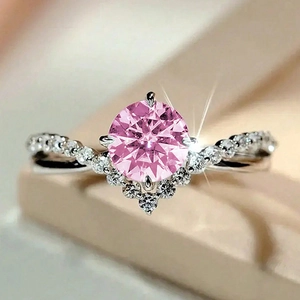Macro shot of a pink zircon ring featuring a V-shaped setting and twisted band
