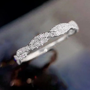 Makroaufnahme von gedrehtem Ewigkeitsring aus Silber mit funkelndem Mikro-Pavé-Besatz