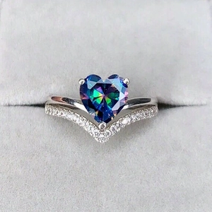 Macro shot of V-shaped ring with rainbow heart stone and micro-pave setting
