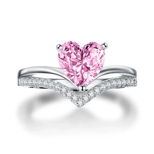 Detail of V-shaped heart ring with pink zircon gemstone and micro-pave setting