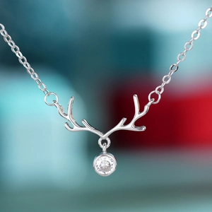 Elegant silver reindeer antler pendant necklace with a round clear gemstone for women
