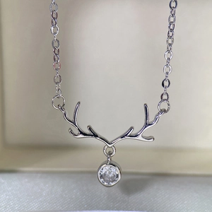 Macro detail of silver elk antler pendant with a sparkling round zircon stone