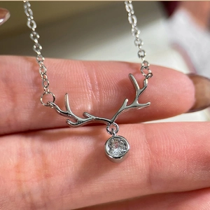 Macro shot of silver reindeer antler pendant with a sparkling zircon on O-chain